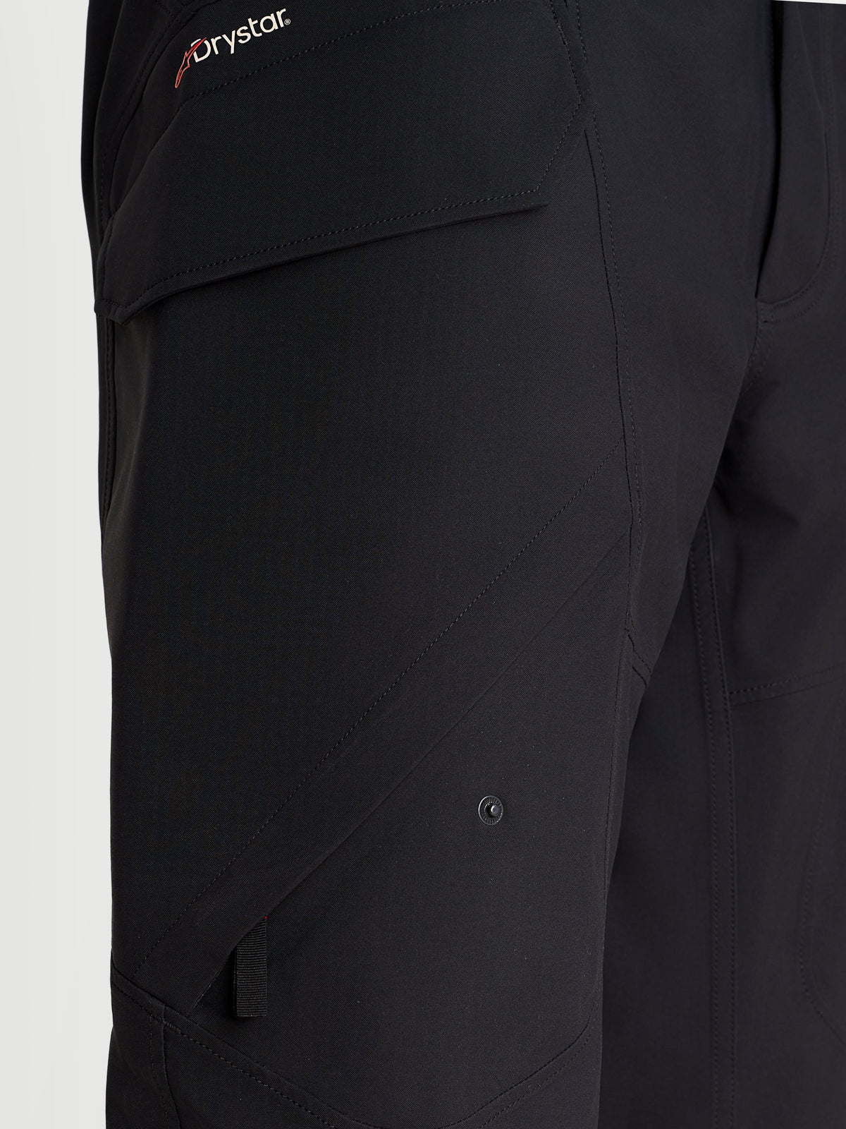 Alpinestars Juggernaut V2 Drystar Pants, men's waterproof urban motorcycle pants in black, close-up view highlighting the side cargo pocket and Drystar branding