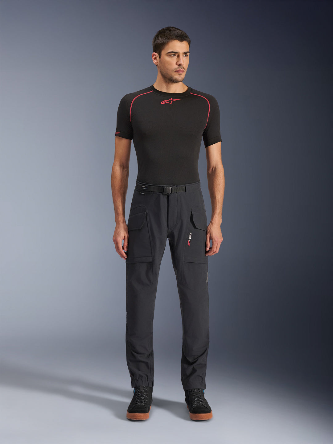 Alpinestars Juggernaut V2 Riding Pants, Motorcycle Pants, Dark Gray, Large Cargo Pockets, Belt Loops, Technical Riding Gear, Worn with Black Shirt with Red Accents