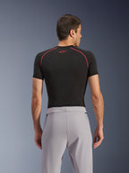 Pantalon Alpinestars Aeroshell Airflow, Gris Moyen, vue de dos, porté avec un vêtement de corps noir à manches courtes avec coutures et logo rouges, doté d'un textile softshell extensible léger et de panneaux en maille pour une ventilation maximale, coupe sport ergonomique pour la conduite à moto