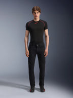 Alpinestars Copper V3 Denim Pants in Black Rinse, regular comfort straight-leg fit, worn by a male model with a black base layer t-shirt featuring red contrast stitching and black riding sneakers, urban motorcycle apparel ensemble