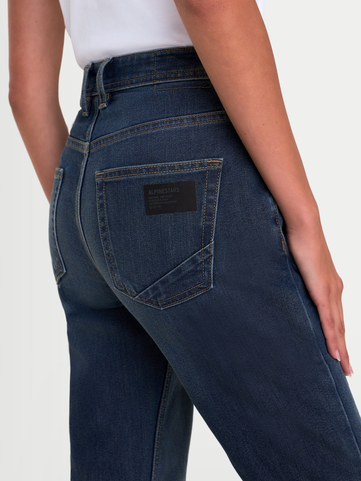 Alpinestars Stella Flex-AST 5 Denim Pants Short, women's urban motorcycle riding jeans, indigo washed blue, rear view showing single-layer tech denim construction and raised waistband worn by a model