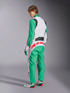 Alpinestars KMX-9 V3 Graphic 6 Suit, Karting Suit, White Green and Red, model viewed from the back-side, featuring green sleeves and lower panels, white upper torso with black speckle detail, bold red Alpinestars branding across the lower back, paired with matching white and green karting shoes.