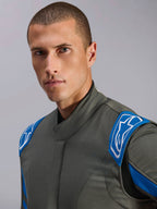 Alpinestars GP Race V3 Suit FIA, Anthracite Blue auto racing suit, close-up shot of a model showing the upper suit design with blue shoulder epaulettes and white Alpinestars logos, professional motorsport gear.