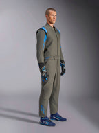 Alpinestars GP Race V3 Suit FIA in Anthracite Blue, one-piece auto racing suit worn by a male model, features bright blue accents on the shoulders and ankles, paired with coordinating racing gloves and blue racing shoes, professional motorsport gear.