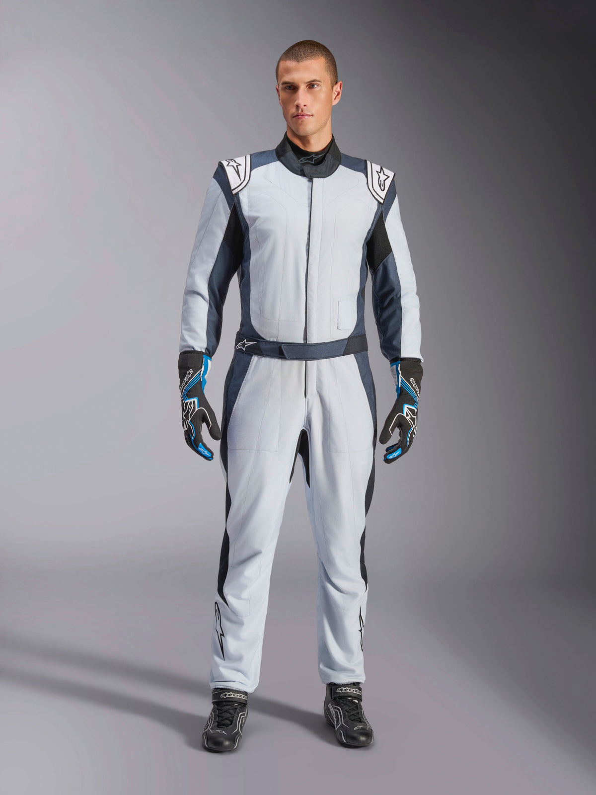 Alpinestars GP Pro Comp V2 FIA Suit, Silver Blue and Asphalt auto racing suit, FIA certified aramidic design, on model.