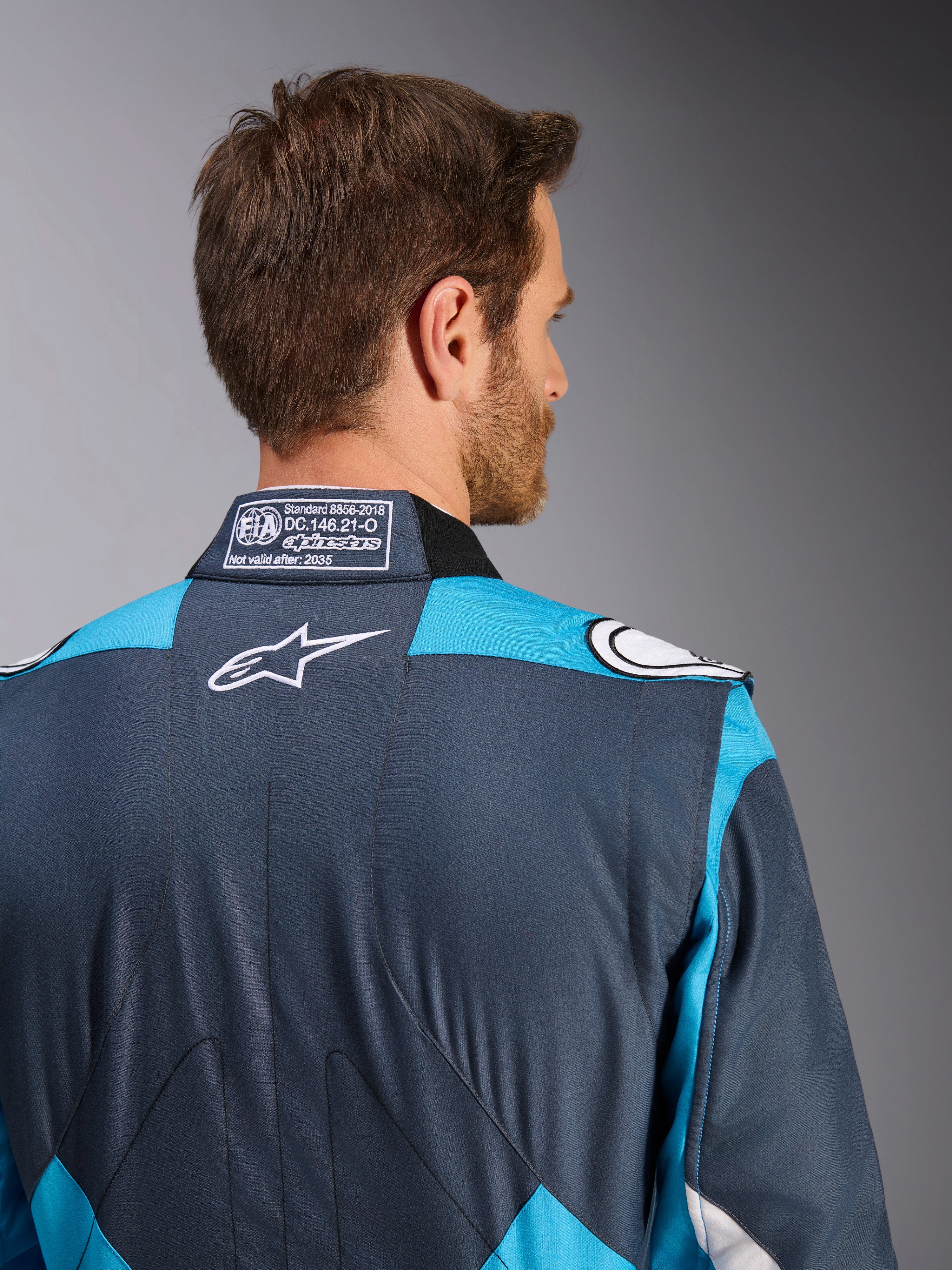 Alpinestars GP Pro Comp V2 FIA Men's Auto Racing Suit, Asphalt and Cyan, with white logo and FIA collar label.