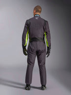 Full-body rear view of a person wearing the Alpinestars KMX-9 V3 Graphic 3 Suit, Karting Suit in Black and Yellow Fluo, showing ergonomic stretch panels on the back and shoulders, paired with black racing gloves and footwear.