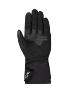 Gants Alpinestars Wt-1 Drystar® Insulated, gants de moto, noirs, vue de la paume présentant des zones de préhension en textile renforcé, manchette longue avec logo Alpinestars blanc sur la sangle, construction résistante aux intempéries pour la conduite sur route