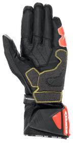 Gants Alpinestars GP Tech V2, noir, blanc et rouge fluo, vue de la paume montrant la construction en cuir noir avec surpiqûres contrastées jaunes, manchette de protection DFS avec accents rouges, équipement professionnel de moto de course