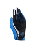 Alpinestars Supertech MX Gloves, Motocross Gloves, Ucla Blue and Deep Blue with White accents, palm view showing black perforated material, white Alpinestars logo, silicone finger grips, and technical text, professional off-road racing gear