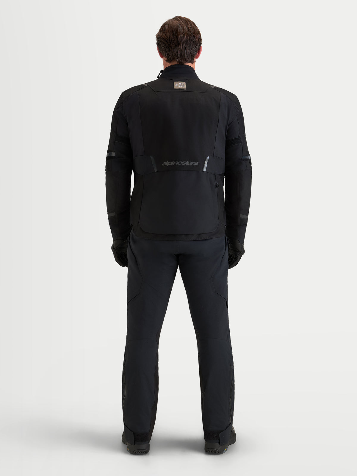 Alpinestars St-7 V2 2L Gore-Tex Veste, veste de moto adventure pour homme noire, vue de dos montrant la construction technique et le marquage Alpinestars