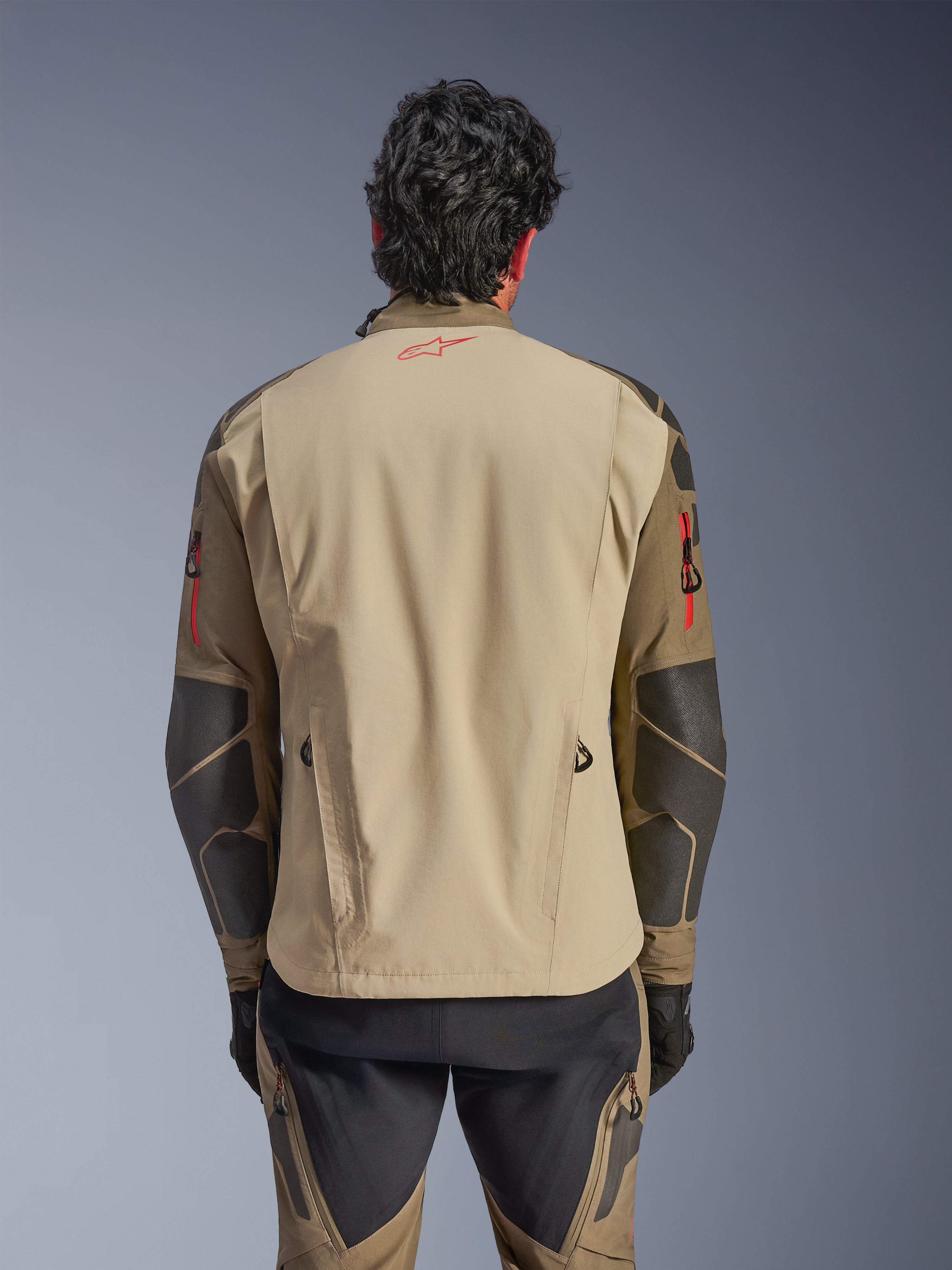Alpinestars Nazca 3L GORE-TEX PRO Jacket, back view, Walnut Rock Brown, adventure motorcycle jacket with red Astars logo on neck and red zipper accents on arms, featuring Superfabric reinforcements on elbows.