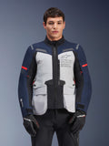 Alpinestars ST-7 2L GORE-TEX Jacket, Motorcycle Adventure Touring Jacket, Ice Gray and Dark Blue with Red accents, Waterproof and breathable, worn by a model with black gloves, featuring Alpinestars Exploration Equipment branding on the chest