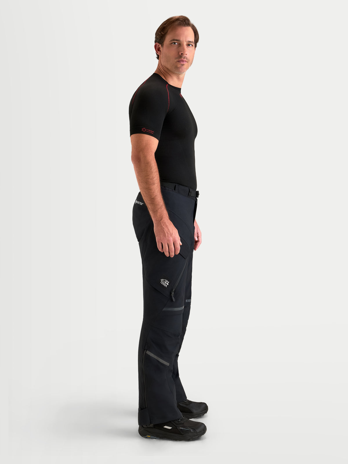 Alpinestars St-7 V2 2L Gore-Tex Pants Short, pantalon de moto adventure pour homme noir, vue de profil latéral sur un modèle portant un équipement de conduite technique imperméable