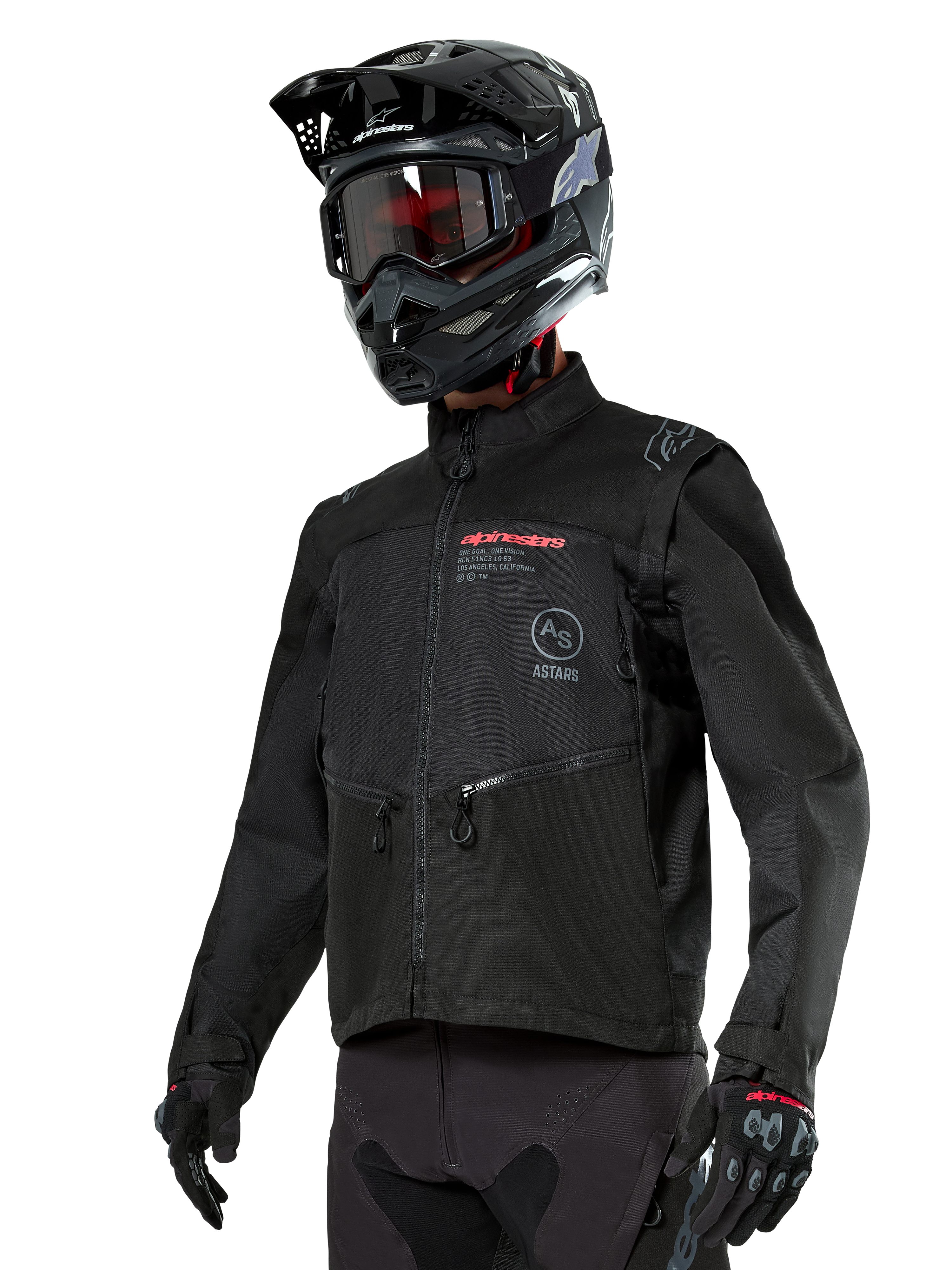 Alpinestars Pro-Dura Jacket, veste de moto tout-terrain, noire avec logos rouges et gris, dotée de poches avant zippées et d'un col montant, portée avec un casque de motocross noir et des gants pour l'enduro
