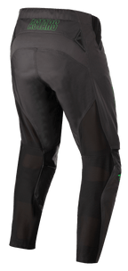 Alpinestars Techstar Phantom Pants, pantalon de motocross, anthracite et vert néon, vue arrière montrant le marquage « ASTARS » vert néon à la taille, panneaux de ventilation en mesh à l'arrière des jambes et assise renforcée pour la durabilité en tout-terrain