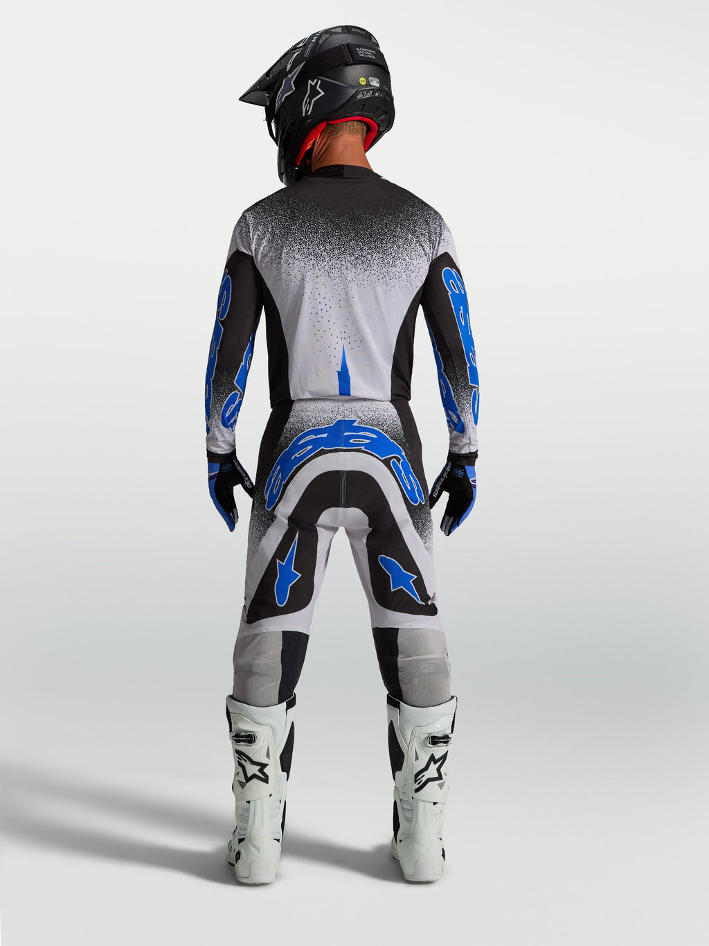 Pantalons Supertech Hiten AFD Alpinestars, équipement de motocross pour homme, bleus et blancs, vue de dos athlétique.