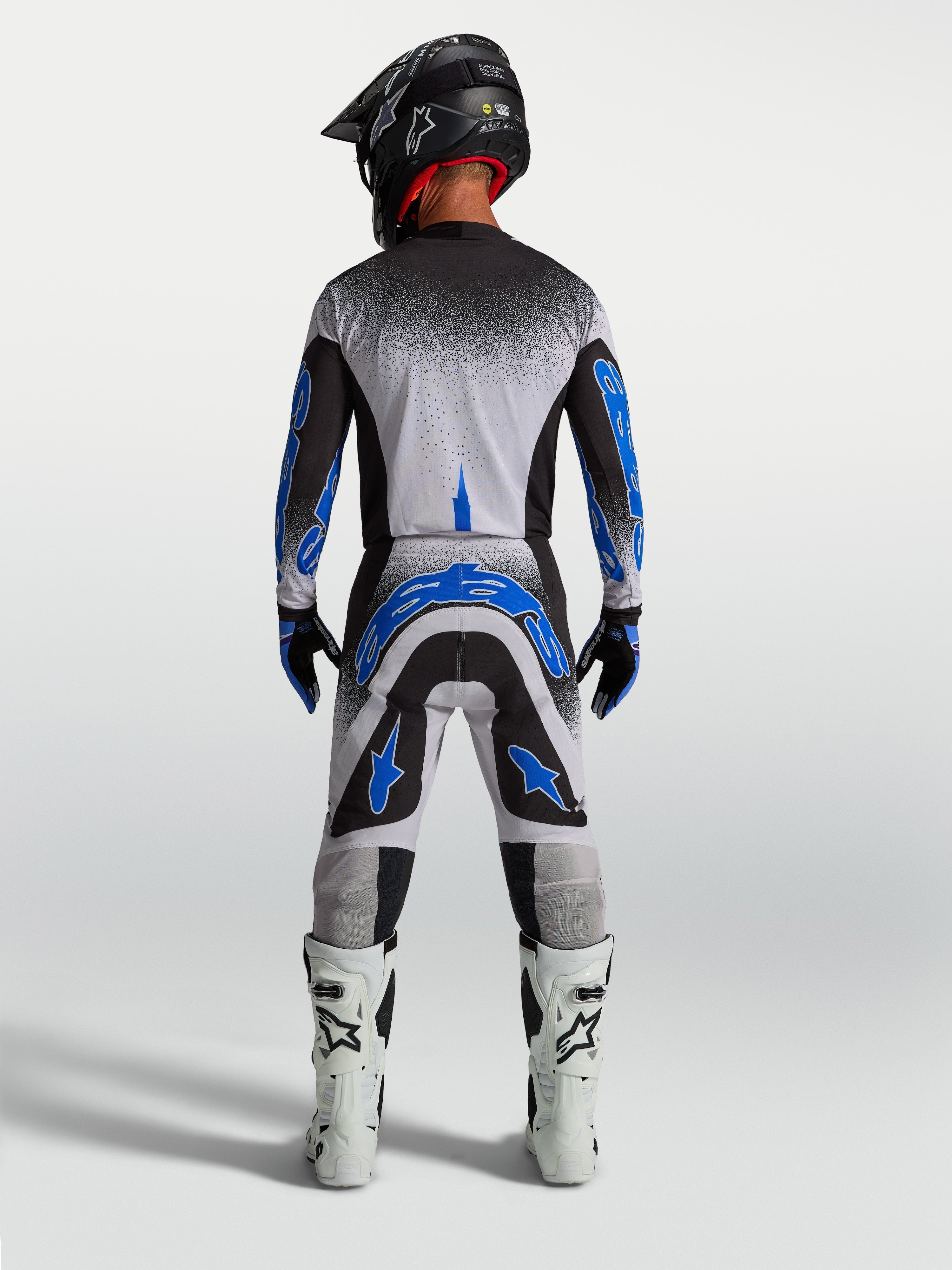 Pantalons Supertech Hiten AFD Alpinestars, équipement de motocross pour homme, bleus et blancs, vue de dos athlétique.