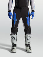 Alpinestars Supertech Hiten AFD, pantalons de motocross pour homme, noirs et bleus, construction en ripstop extensible léger.