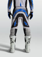 Alpinestars Supertech Hiten AFD, pantalons de motocross homme, bleus, noirs et blancs, coupe athlétique, vus de dos.