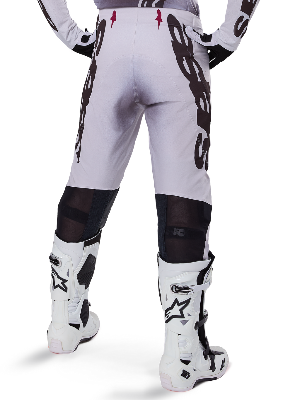 Alpinestars 2025 Supertech Maker Pants, Motocross Pants, Silver and Black, back view showing large black logos on thighs and breathable mesh zones behind the knees, worn with white Alpinestars boots.