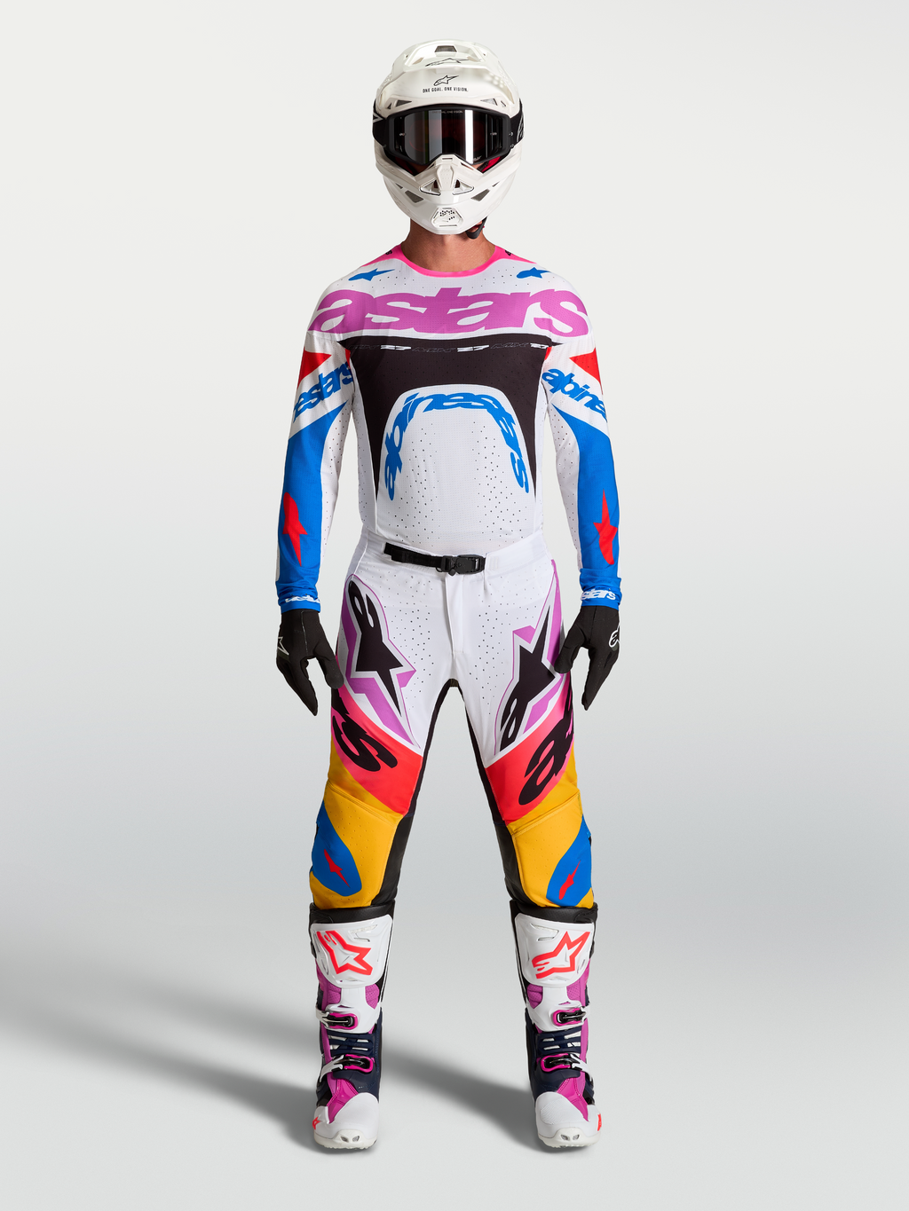 Alpinestars Supertech Dyna Pants and gear set, men's white and blue motocross racing outfit with pink accents.