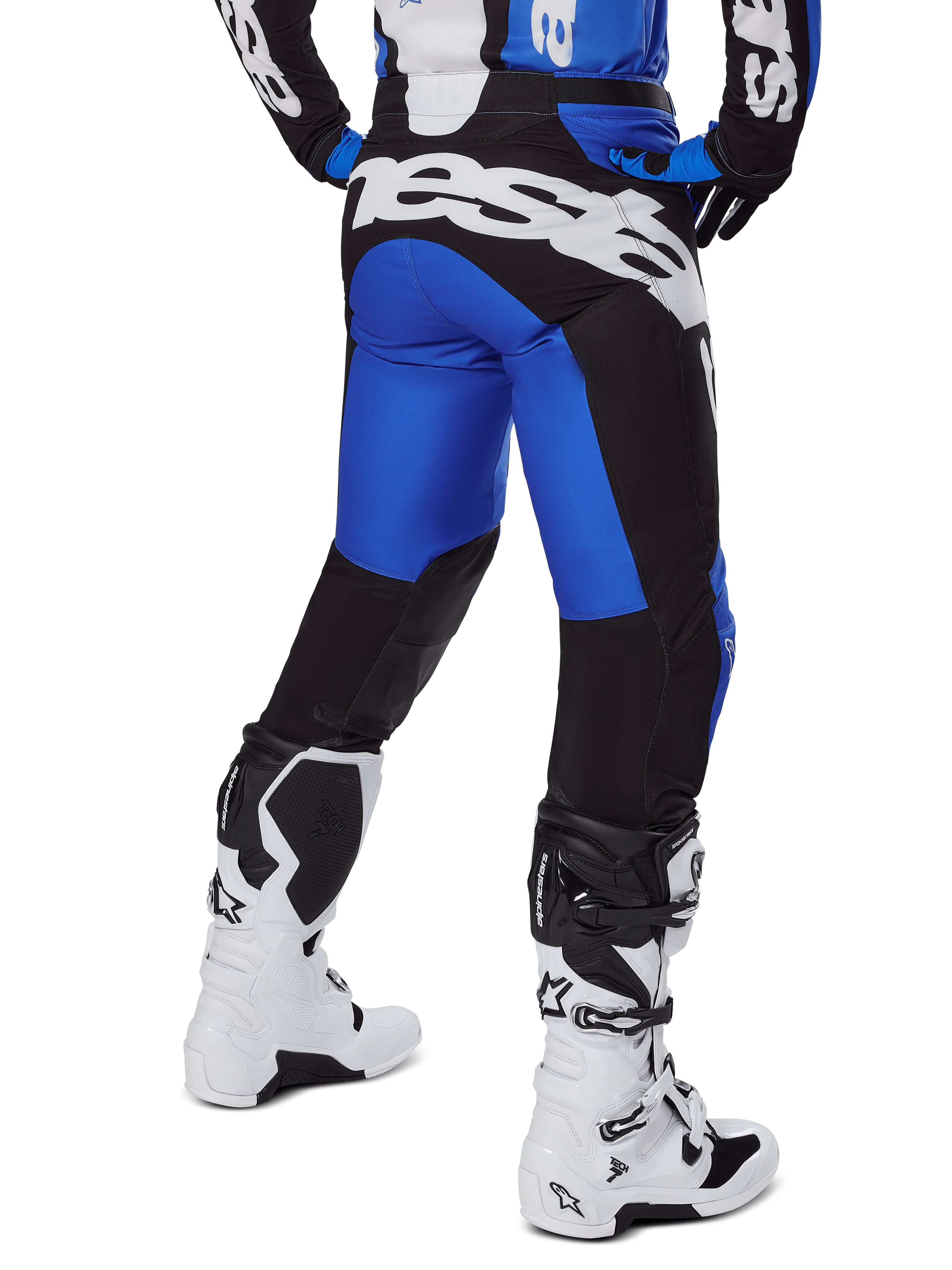 Alpinestars 2025 Racer Veil Pants, Motocross Pants, Blue and Black, rear view showing large white branding on the seat, worn with matching jersey and white boots, durable technical material for off-road riding