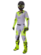 Alpinestars 2025 Racer Veil Pants, Motocross Pants, Gray and Yellow Fluo, worn with matching jersey, black helmet, fluo yellow goggles, boots, and gloves, coordinated off-road racing outfit featuring bold branding and ergonomic design.