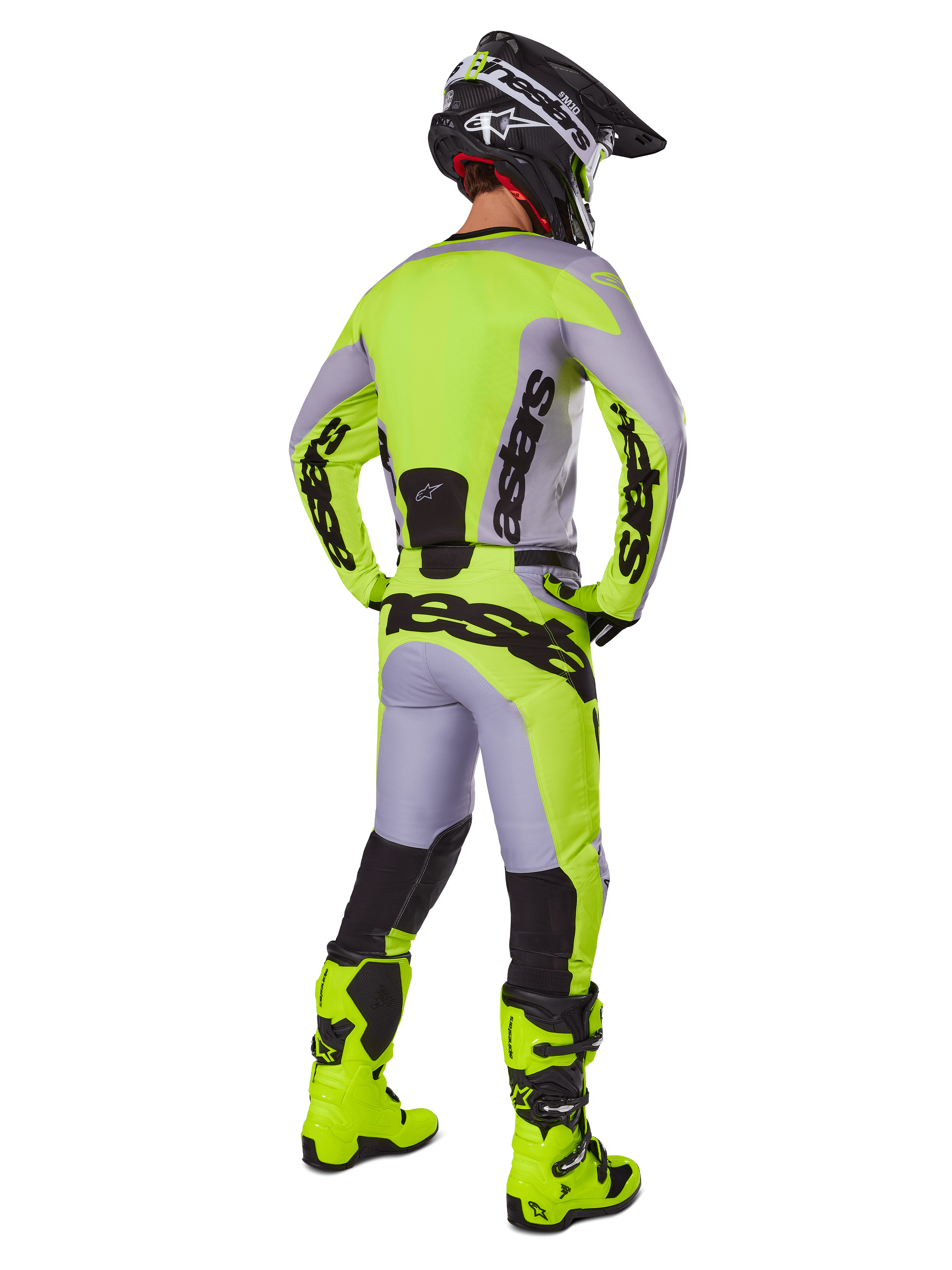 Alpinestars 2025 Racer Veil Pants, Motocross Pants, Gray and Fluorescent Yellow, rear view of rider in full gear, matching jersey and fluo yellow boots, featuring bold black logos, technical off-road racing kit.