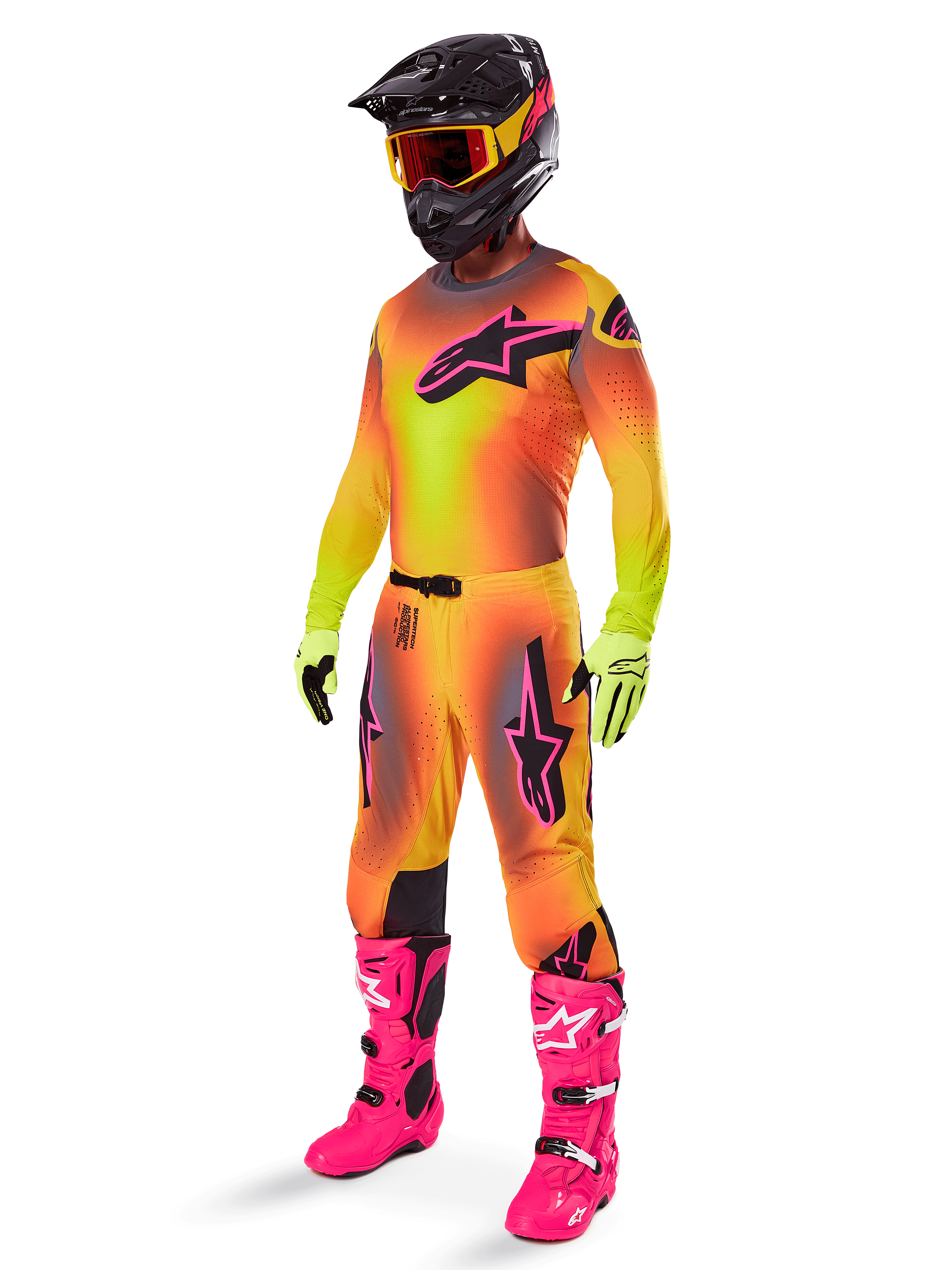 Alpinestars 2025 Supertech Lipan Pants, Motocross Pants, Yellow and Pink, worn as part of a full gear set with matching gradient jersey, bright pink boots, yellow gloves, and black helmet, featuring bold black logos and athletic fit for off-road racing