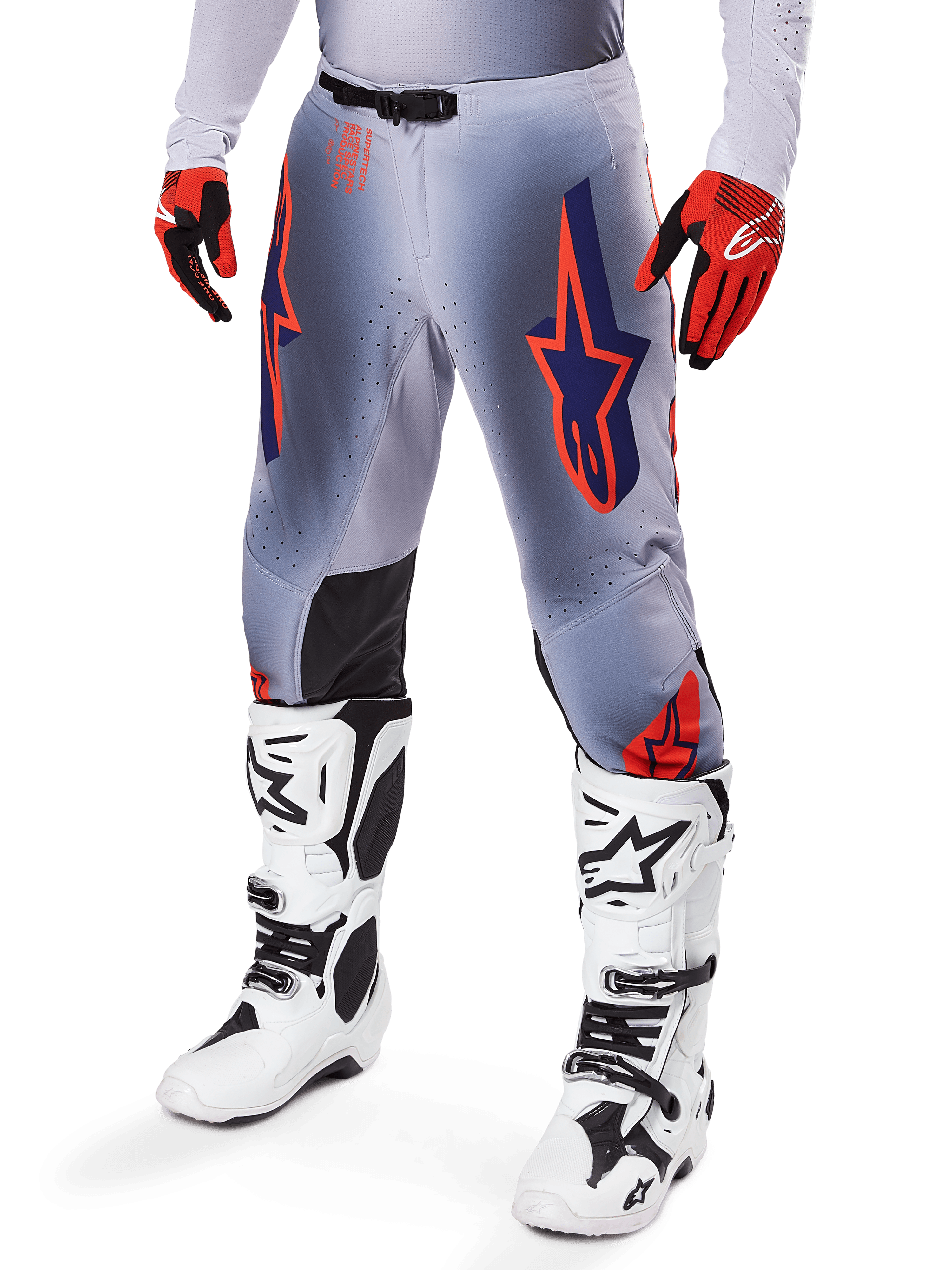 Alpinestars 2025 Supertech Lipan Pants, Motocross Pants, Gray and Orange Fluo, featuring navy star designs and black inner knee panels, worn with red-orange gloves and white boots, professional off-road racing gear