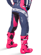 Alpinestars 2025 Techstar Dreem Pants, Motocross Pants, Gray and Pink Multicolor, rear view featuring large white Alpinestars branding across the seat, worn with matching bright pink Tech 10 boots, durable off-road racing gear with reinforced panels.