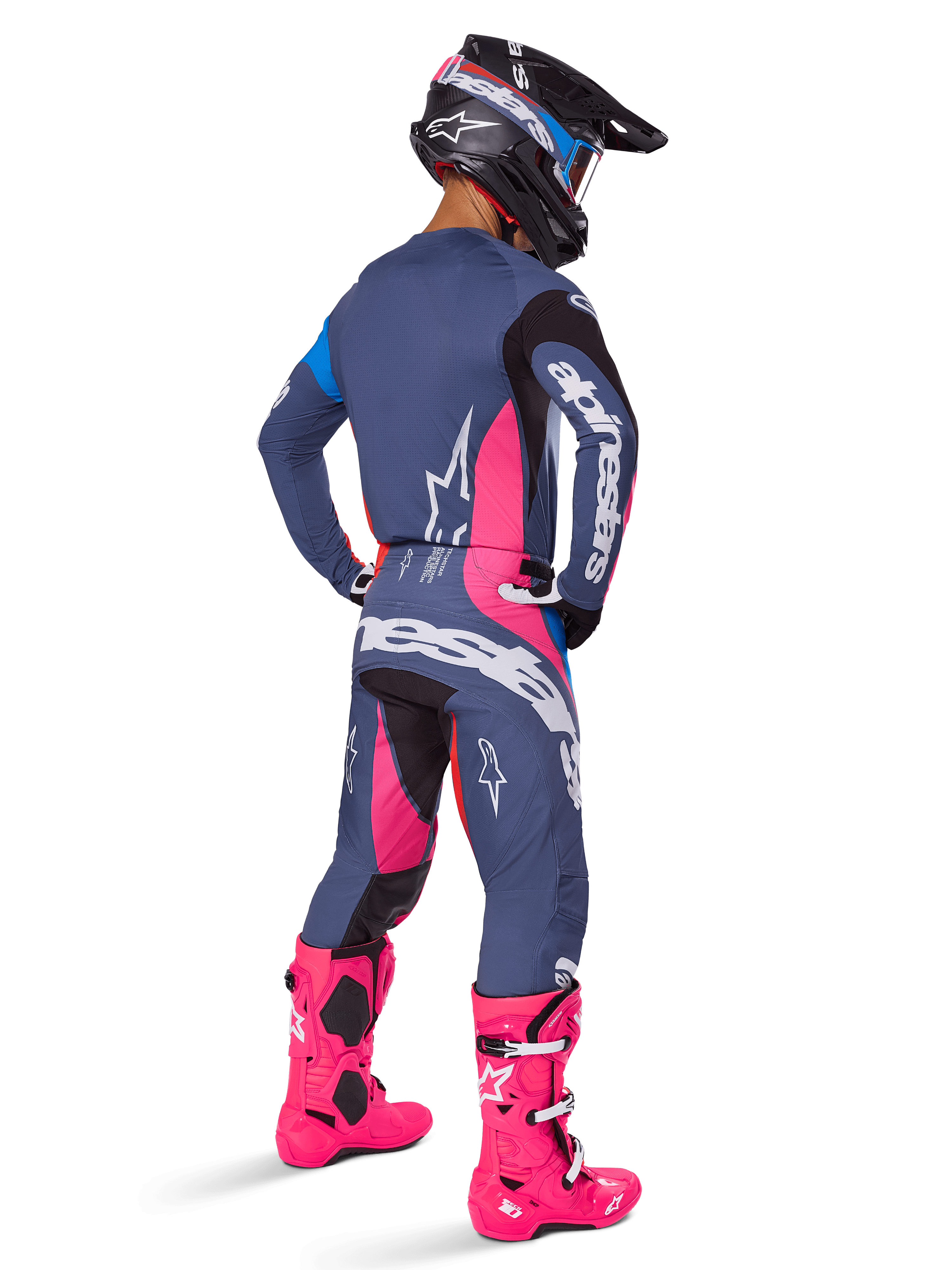 Motocross rider from behind wearing Alpinestars 2025 Techstar Dreem Pants, Gray-blue and Magenta pink design with black accents, worn with a matching jersey and vibrant pink boots, athletic race fit for off-road performance.