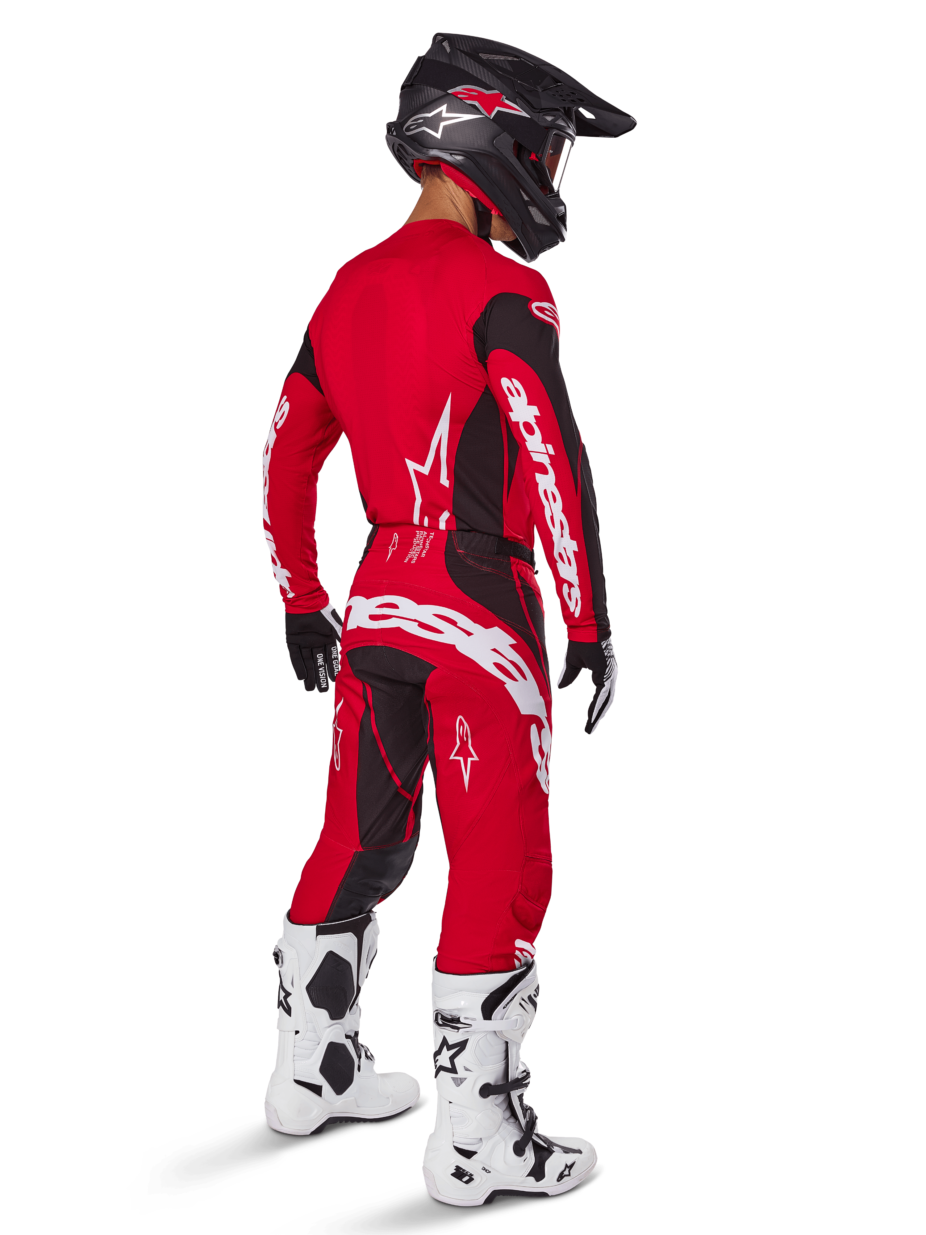 Pantalon Alpinestars Techstar Dreem 2025, pantalon de motocross, rouge vif et noir, porté par un pilote vu de dos dans une tenue de course complète avec maillot rouge assorti, casque noir et bottes blanches, avec logo Alpinestars blanc et empiècements extensibles noirs.