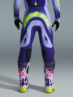 Alpinestars 2026 Supertech Scenz Pants, Motocross Pants, Purple and Yellow Fluo, rear view showing large yellow logo on seat, worn with matching jersey, gloves, and protective boots, athletic fit for professional motocross racing.