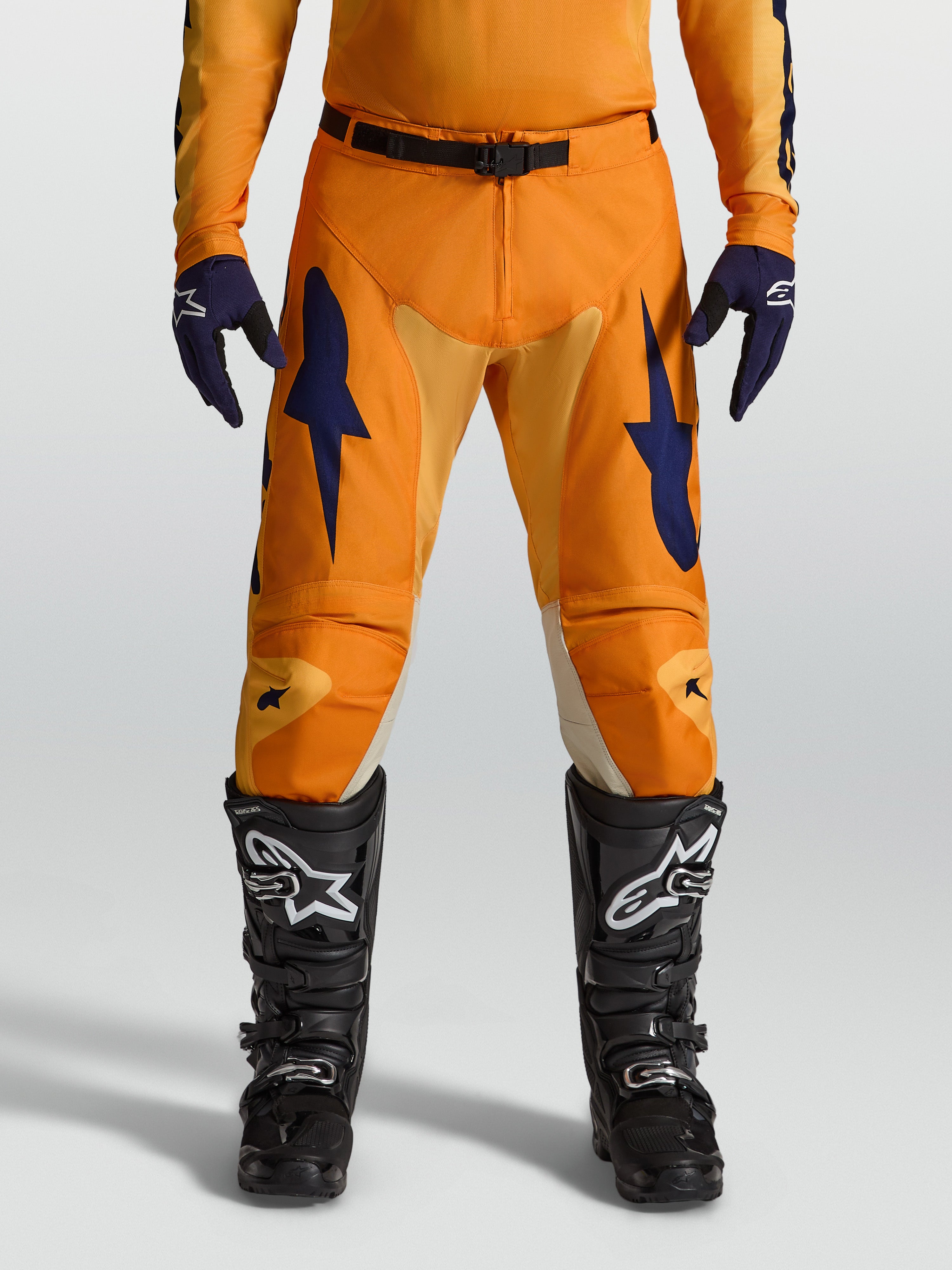 Alpinestars Racer Amber Motocross Pants in orange and deep blue, with durable 600D polyfabric and race fit.