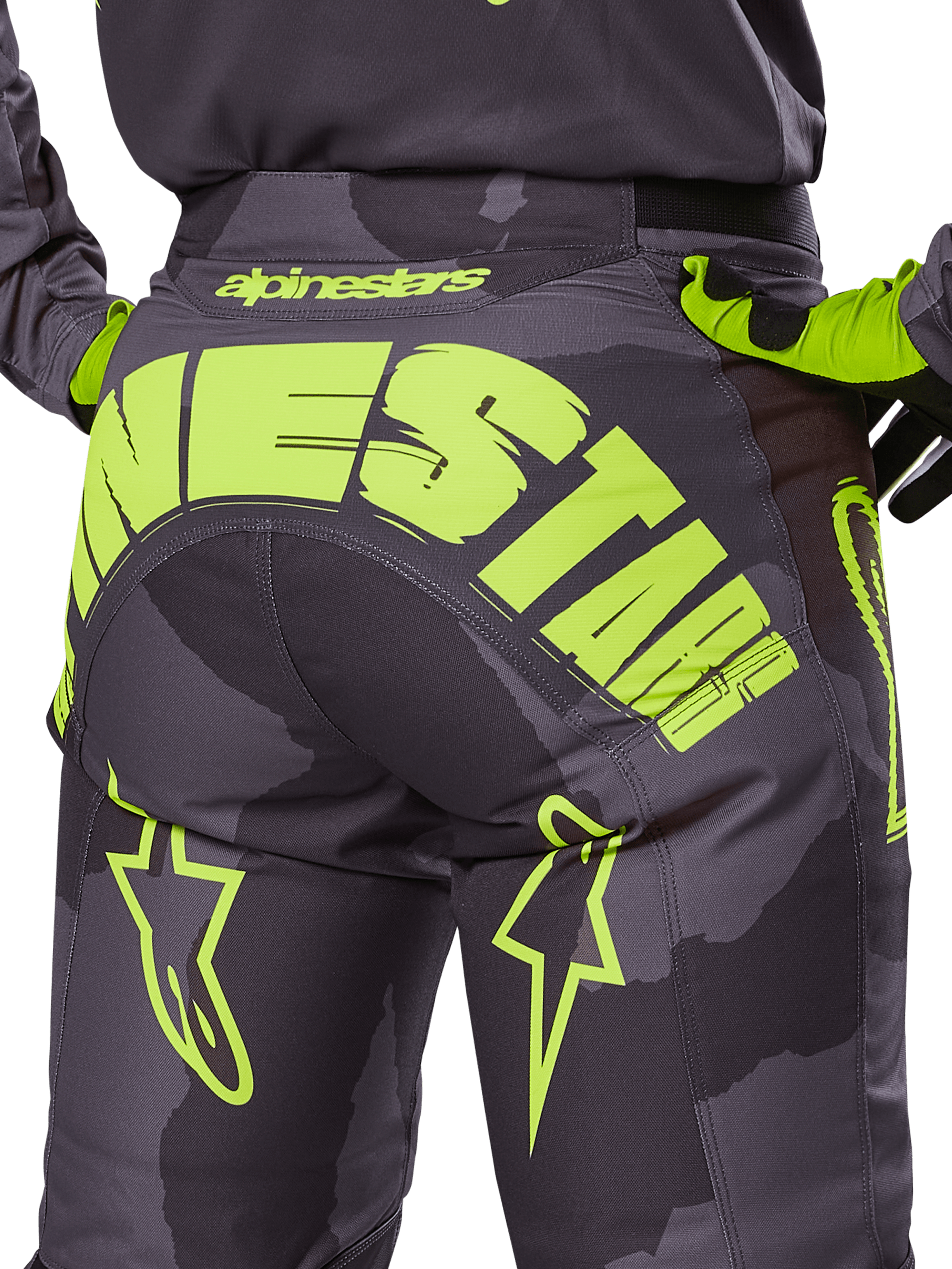 Alpinestars 2025 Racer Hollow Pants, Motocross Pants, Dark Camo and Yellow Fluo, featuring a large yellow Alpinestars logo across the rear, tactical camo pattern with bright yellow accents, and durable construction for off-road racing.
