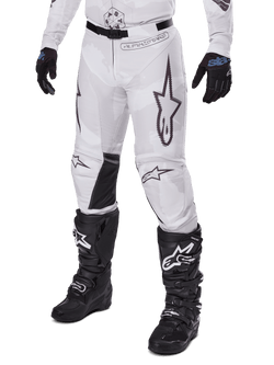 Alpinestars 2025 Racer Hollow Pants, Motocross Pants, White and Grey Camo, featuring large black outlined star logos and black leather inner knee panels, worn with black motocross boots and gloves, durable design for off-road racing.
