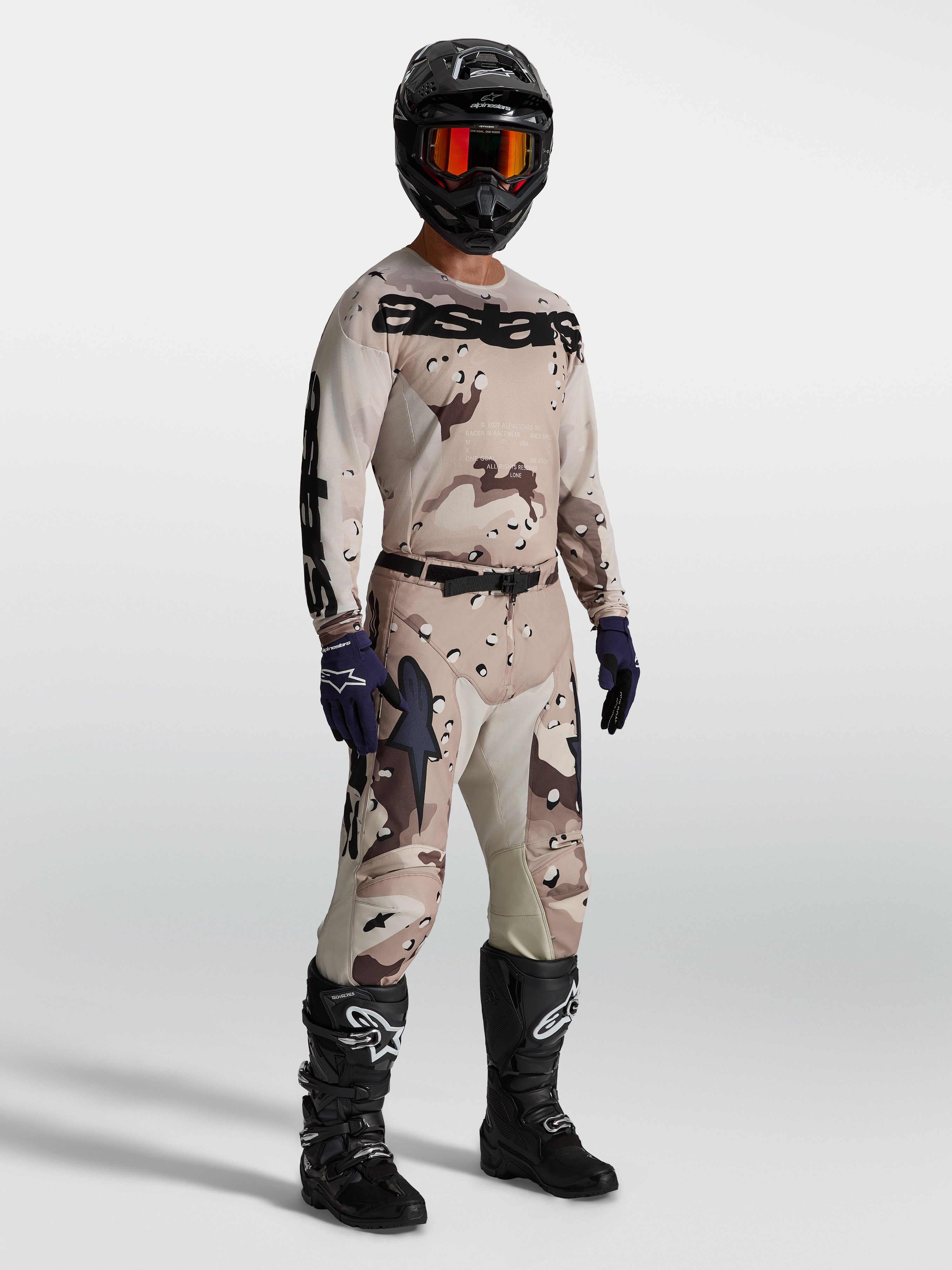 Alpinestars Racer Lone Gear Set, tan and brown camo motocross jersey and pants, with black boots for off-road performance.