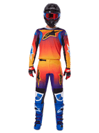 Alpinestars 2025 Fluid Wurx Pants, Motocross Pants, Multicolor orange yellow and purple gradient, worn with matching jersey, black helmet with blue goggles, red and black gloves, and blue boots, coordinated motocross racing gear