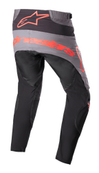 Alpinestars Pantalon Techstar Sein 2023, pantalon de motocross, noir et rouge fluo, vue arrière avec empiècement d'assise gris et logo rouge fluo imposant, jambes pré-courbées ergonomiques, construction textile durable pour la performance tout-terrain.