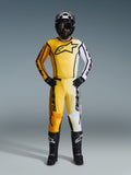 Alpinestars 2026 Fluid Apex Gear Set, Full Motocross suit featuring a yellow orange and white gradient jersey and pants, styled with a black helmet goggles and boots, bold black logo on chest, complete off-road racing protection