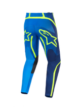 Alpinestars 2026 Fluid Apex Pants, pantalon de motocross, bleu et jaune fluo, vue arrière avec grands contours de logo étoile jaunes, panneaux de genoux internes renforcés et construction en poly-tissu durable pour la course tout-terrain