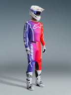 Alpinestars 2026 Fluid Apex Pants, Motocross Pants, Multicolor gradient of purple, pink, and orange, worn with matching jersey, white helmet, and white boots, featuring bold white branding and ergonomic design for off-road racing