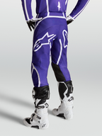Alpinestars Fluid Apex V2, pantalon de motocross pour homme, bleu foncé et blanc, vue de dos montrant le logo étoile et la coupe ergonomique 3D.