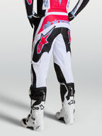 Pantalon Fluid Drag Alpinestars, pantalon de motocross pour homme blanc et noir avec accents rouges et bleu clair.