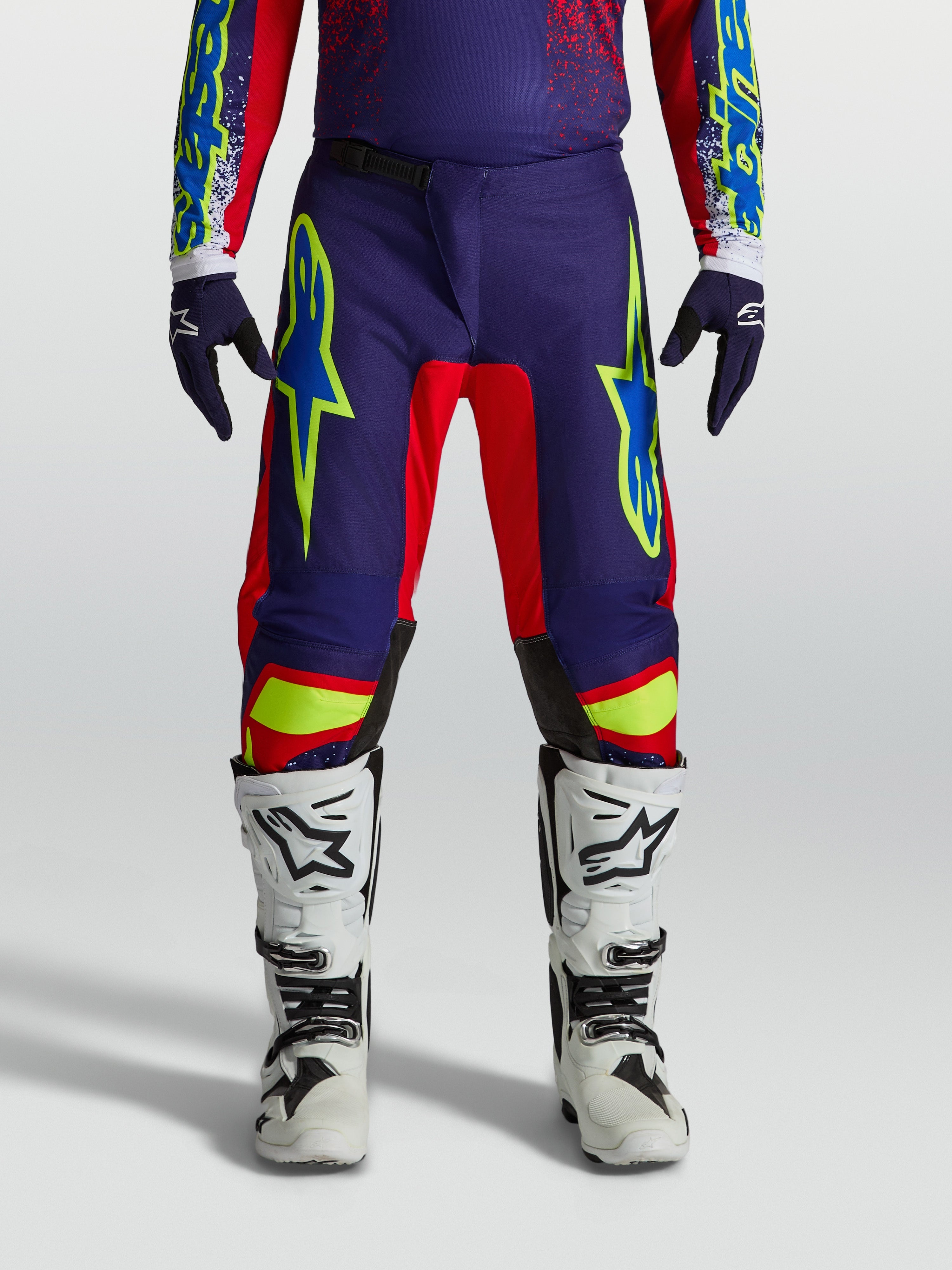 Alpinestars Pantalons Fluid Drag, équipement de motocross performance pour homme, bleu marine et rouge feu, avec une coupe sport durable.