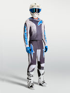 Alpinestars Fluid Drag Pants and gear set, gray and blue motocross apparel with an ergonomic 3D design for performance.