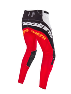 Alpinestars Techstar Deep Édition Limitée, pantalon de motocross, coloris noir, blanc et rouge fluo, vue arrière montrant le large marquage Alpinestars blanc sur l'assise, des logos orange sur le haut des jambes et des empiècements en cuir noir à l'intérieur des genoux, conçu pour la compétition tout-terrain professionnelle.