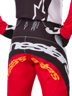 Alpinestars Techstar Deep Édition Limitée, pantalon de motocross, noir, blanc et rouge vif, avec une conception multi-panneaux, des genoux renforcés et des empiècements extensibles quadridirectionnels pour des performances tout-terrain